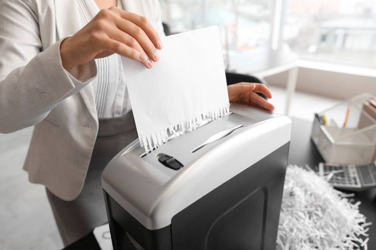 Paper shredder being used by office employee