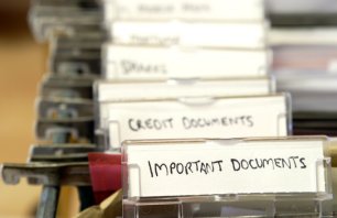 Detail of a filing cabinet with tabs labelled for important documents, credit documents, etc.