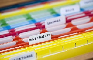 Open file folder drawer with many multicolored files containing personal finance documents